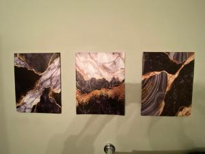a group of four pictures hanging on a wall at Downtown CLE Loft, River View, King Bed, Free Parking in Cleveland