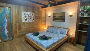 a bedroom with a bed with two hats on it at Jungle Bluff Beach Paradise - Jungle House in Paunch