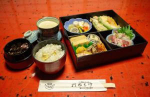 a tray of food on a table with sushi and rice at 芹生庵 in Kyoto