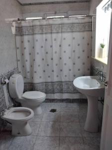 a bathroom with a toilet and a sink at Roxi Aristides in Mendoza
