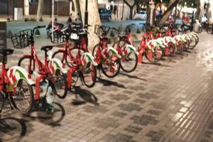 a bunch of bikes parked in a row on a sidewalk at Roxi Aristides in Mendoza