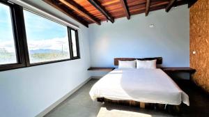 Voodi või voodid majutusasutuse Xinghaiwan B&B toas