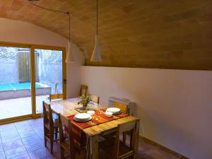 a kitchen with a wooden table with chairs and a dining room at Casa L'Armentera, 3 dormitorios, 6 personas - ES-89-123 in Ventalló