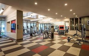 a gym with treadmills and machines in a room at Stylish Downtown Retreat in Houston
