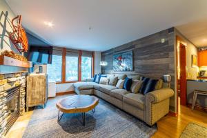 a living room with a couch and a table at Luxurious Remodeled Village Oasis in Mammoth Lakes