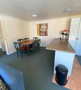 a dining room with a table and chairs at Tairua Dream in Tairua