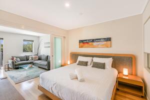 a bedroom with a large bed and a couch at Pool View Apartments at Peppers Salt Resort by uHoliday 2BR 1BR and Hotel Room Options Available in Kingscliff