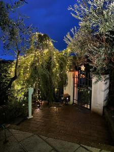 a garden with lights on a house at night at Castellino di Malborghetto in Montelupo Fiorentino