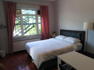 a hotel room with two beds and a window at RAZI TURIZM in Istanbul