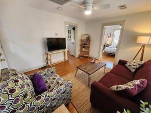 a living room with a couch and a tv at Cute & Quiet Garage Apt Home in Houston