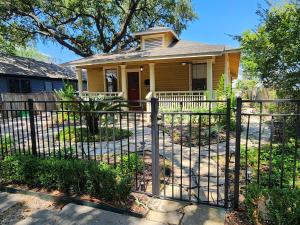 a small house with a fence in front of it at Cute & Quiet Garage Apt Home in Houston