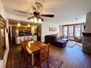 a living room with a table and a ceiling fan at Quiet, Updated, Corner Condo in the Village! Parking, Pool & Spa in Mammoth Lakes