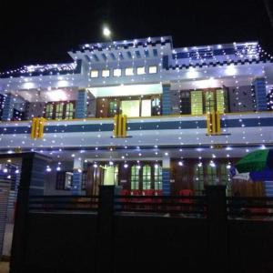 a large building with lights on it at night at Honey Paradise Homestay in Trivandrum
