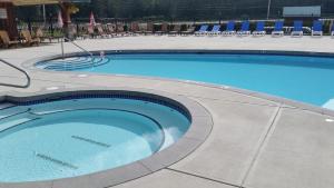 a large swimming pool with chairs in a hotel at Sunshine Valley RV Resort and Cabins in Sunshine Valley