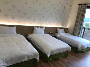 Postel nebo postele na pokoji v ubytování 花蓮太平洋會館民宿