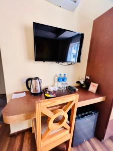 a room with a desk with a television on the wall at Bodhi Boutique Hotel in Kathmandu