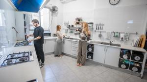 a group of people standing in a kitchen at Mad Monkey East Side in Sydney +47 photos