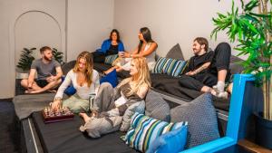 a group of people sitting in a living room at Mad Monkey East Side in Sydney