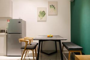 a kitchen with a table and chairs and a refrigerator at 3Towers @ KL City Centre in Kuala Lumpur