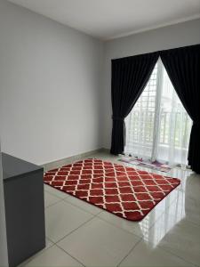 a room with a red rug in front of a window at THE LOFT Mahogany Bandar Puteri, Bangi in Kajang +4 photos