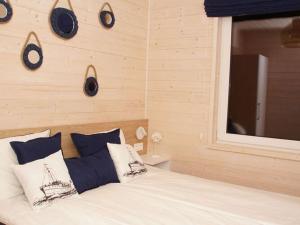 a bedroom with a bed with clocks on the wall at Comfortable holiday cottages, Mielenko in Mielenko