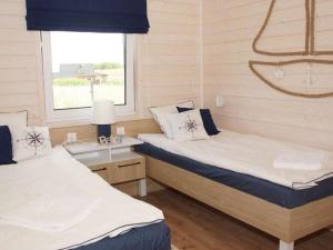 a bedroom with two beds and a window at Comfortable holiday home, Mielenko in Mielenko