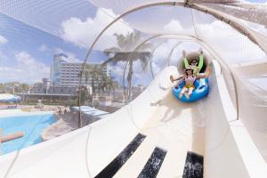 a man and a child riding a ride at a water park at Saipan World Resort in Susupe