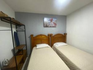 two beds in a small room with at Departamento entero Toluquilla HP/VFG/Iteso in Guadalajara