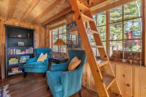 a room with two blue chairs and a ladder at Coziest Cabin in Tahoe w Stone Fireplace Comfy Beds Close to Slopes & Lake in Carnelian Bay