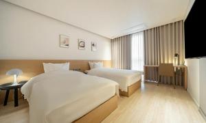 Pohang Hotel Noblion客房内的一张或多张床位