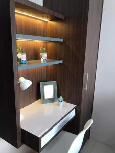 a desk with a mirror on a wooden wall at Skyview Setiabudi Apartment in Sunggal