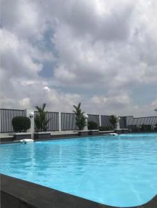 a large blue swimming pool on top of a building at Skyview Setiabudi Apartment in Sunggal