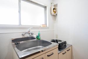a kitchen with a sink and a window at Nagai park side stay in Osaka +94 photos
