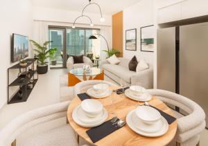 a dining room and living room with a table and chairs at BURJ ROYALE - Luxury 2 bedroom apartment with full burj Khalifa & fountain view- DELUXE in Dubai +48 photos