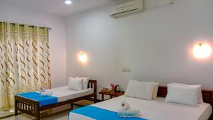 Postel nebo postele na pokoji v ubytování Ceylon Amigos Eco Resort