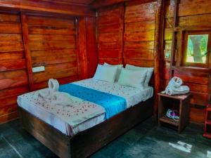 Postel nebo postele na pokoji v ubytování Ceylon Amigos Eco Resort