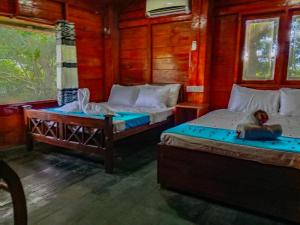 Postel nebo postele na pokoji v ubytování Ceylon Amigos Eco Resort
