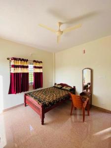 a bedroom with a bed and a chair in it at MISTY COORG GREENS in Madikeri