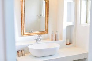 a bathroom with a white sink and a mirror at MORITO Funny house in Hayama +12 photos