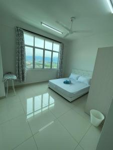 a white room with a bed and a large window at Rumah Puteh Homestay in Ipoh +11 photos