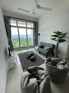 a living room with a large window and a couch at Rumah Puteh Homestay in Ipoh
