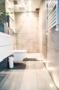 a bathroom with a tub and a toilet and a sink at Apartament Targ Rybny - Gdańsk Old Town in Gdańsk