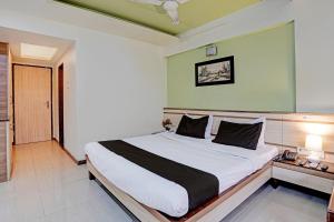 a bedroom with a large bed in a room at Collection O Guru Heritage Kalamboli in Mumbai