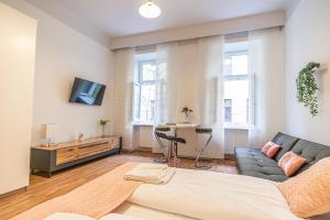 a living room with a couch and a tv at Peaceful Getaway 2BR Apartment with Shared Spaces in Vienna