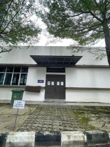 a building with a sign in front of it at Rumah Puteh Homestay in Ipoh