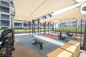 a gym with benches and exercise equipment in a building at Primestay - 15 Northside 2BR in Business Bay in Dubai