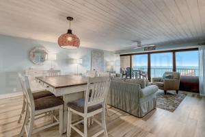 a dining room and living room with a table and chairs at Amelia The Sea - 442 ASea in Fernandina Beach