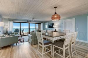 a dining room with a table and chairs and a living room at Amelia The Sea - 442 ASea in Fernandina Beach