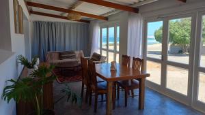 a dining room with a wooden table and chairs at Yield House and Cottages in Port Nolloth