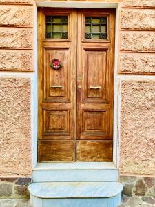 a wooden door of a building with a wreath on it at La Casetta di San Giovanni in Rome